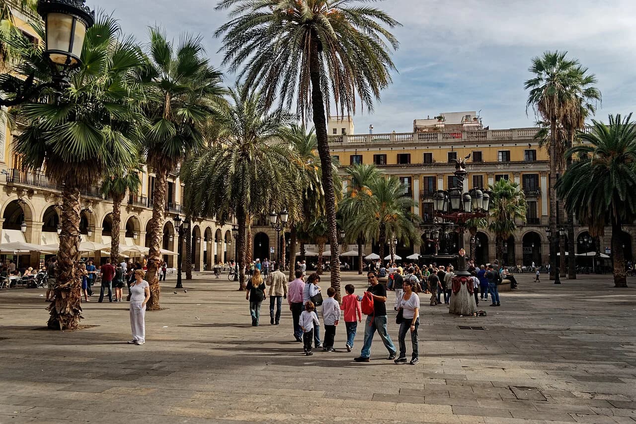 Palm trees and arcaded neoclassical buildings around Plaça Reial, just off La Rambla in Barcelona