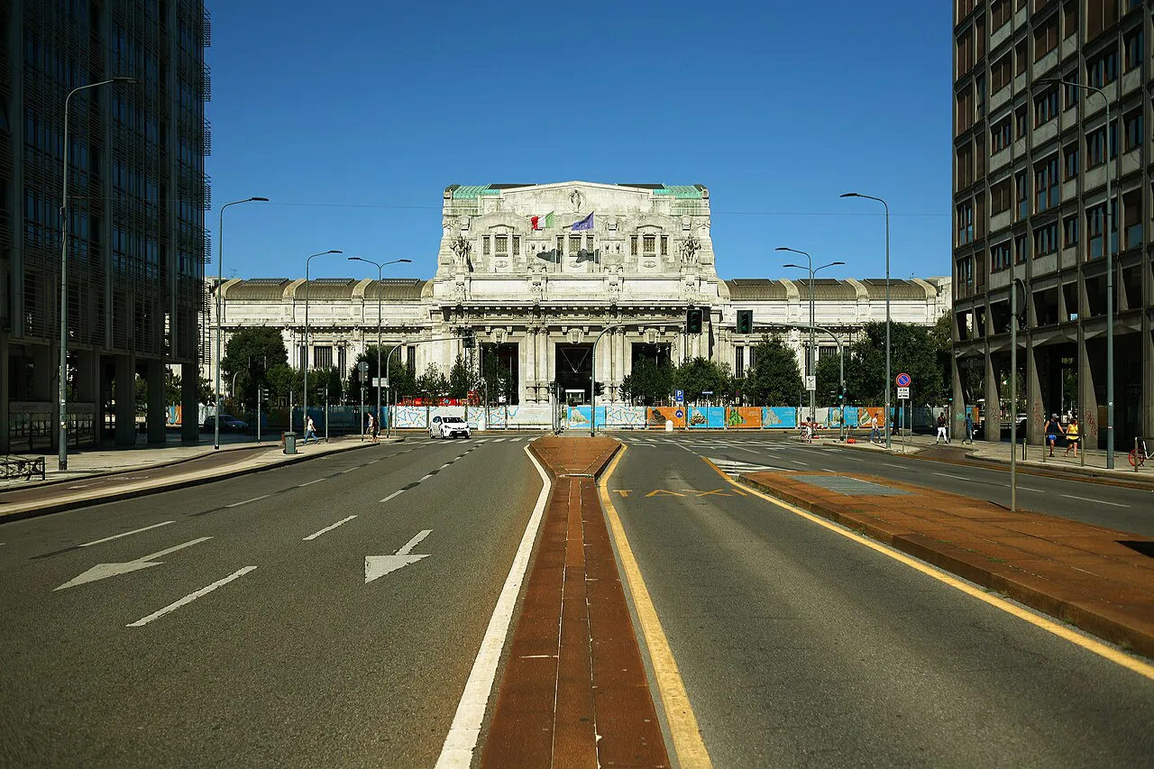 Milano Centrale station facade at the end of Via Vittor Pisani, framed by office towers