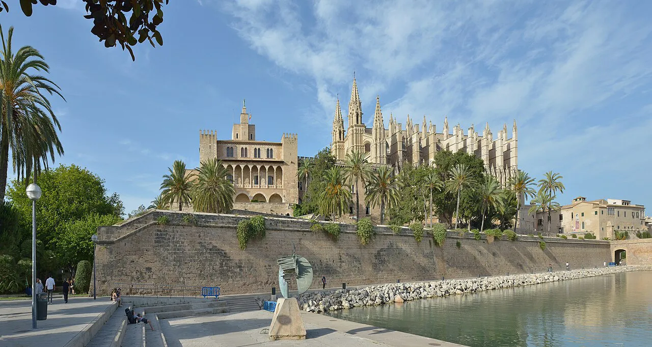 Almudaina Palace and Palma Cathedral rising above the seafront walls and Parc de la Mar