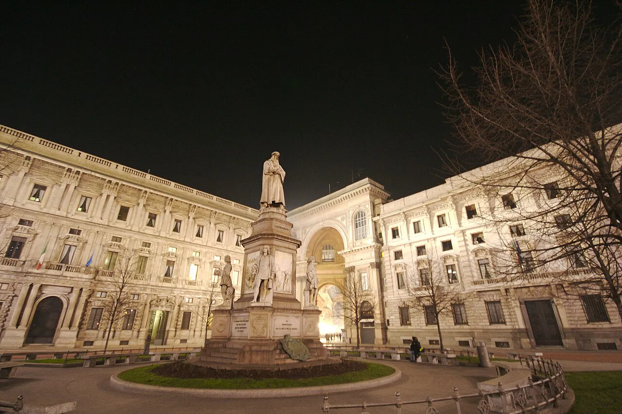 Piazza della Scala in Milan at dusk, with the Leonardo monument, Palazzo Marino and the Galleria entrance