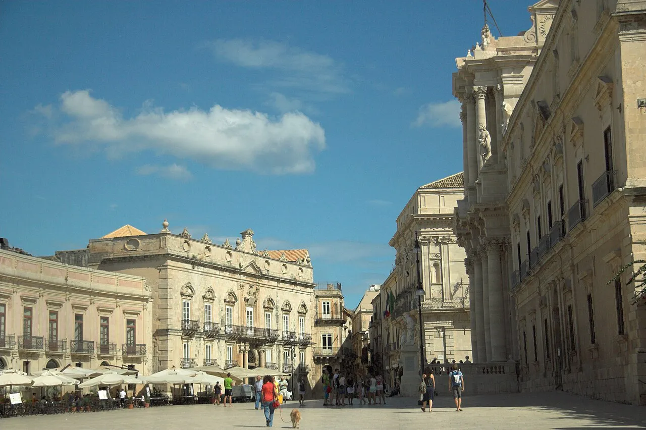 Baroque palazzi and the cathedral facade around the pale stone Piazza Duomo in Ortigia, Siracusa