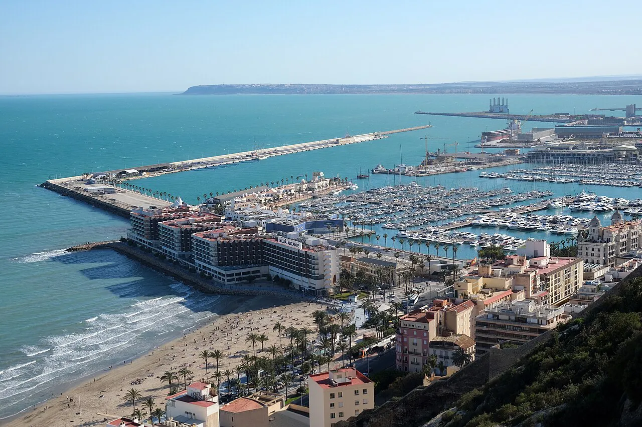 Aerial view of Alicante's port and marina beside the curve of Postiguet beach