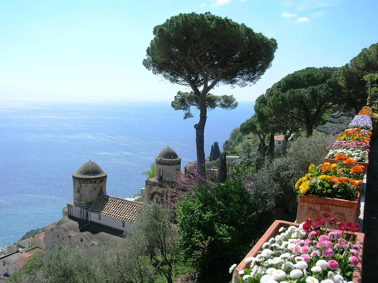 Umbrella pines, flower boxes and old domes in the Villa Rufolo gardens in Ravello above the sea