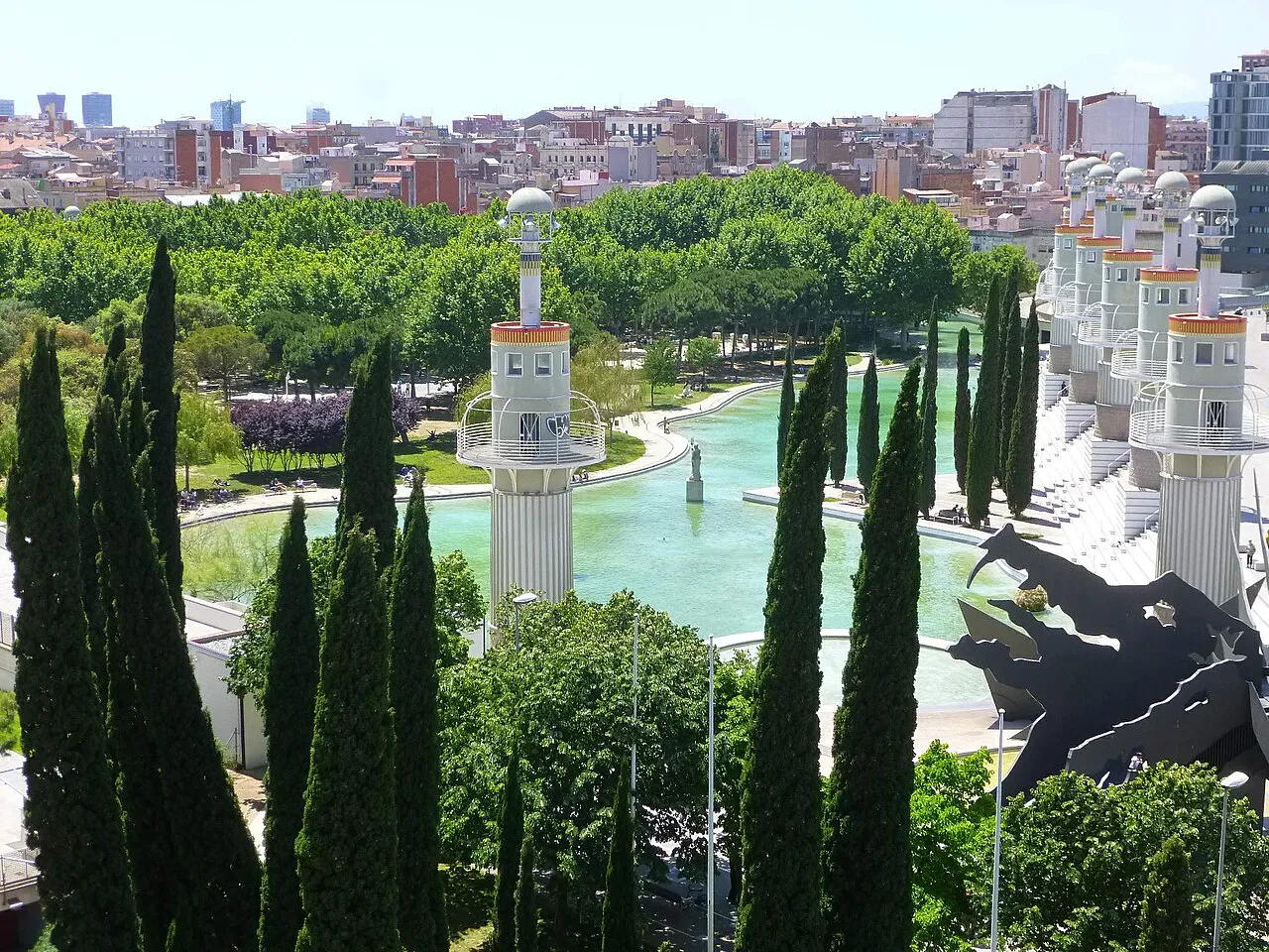 Lighthouse-style towers, cypresses and pond in Parc de l'Espanya Industrial beside Sants, Barcelona