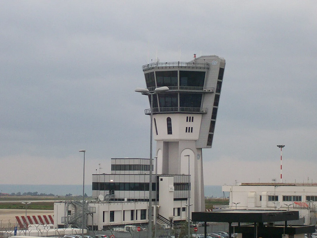 The white control tower and terminal buildings of Bari Karol Wojtyła airport at Palese