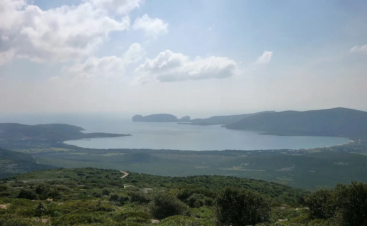 The sheltered bay of Porto Conte and the Capo Caccia headland seen from the green slopes of Monte Doglia