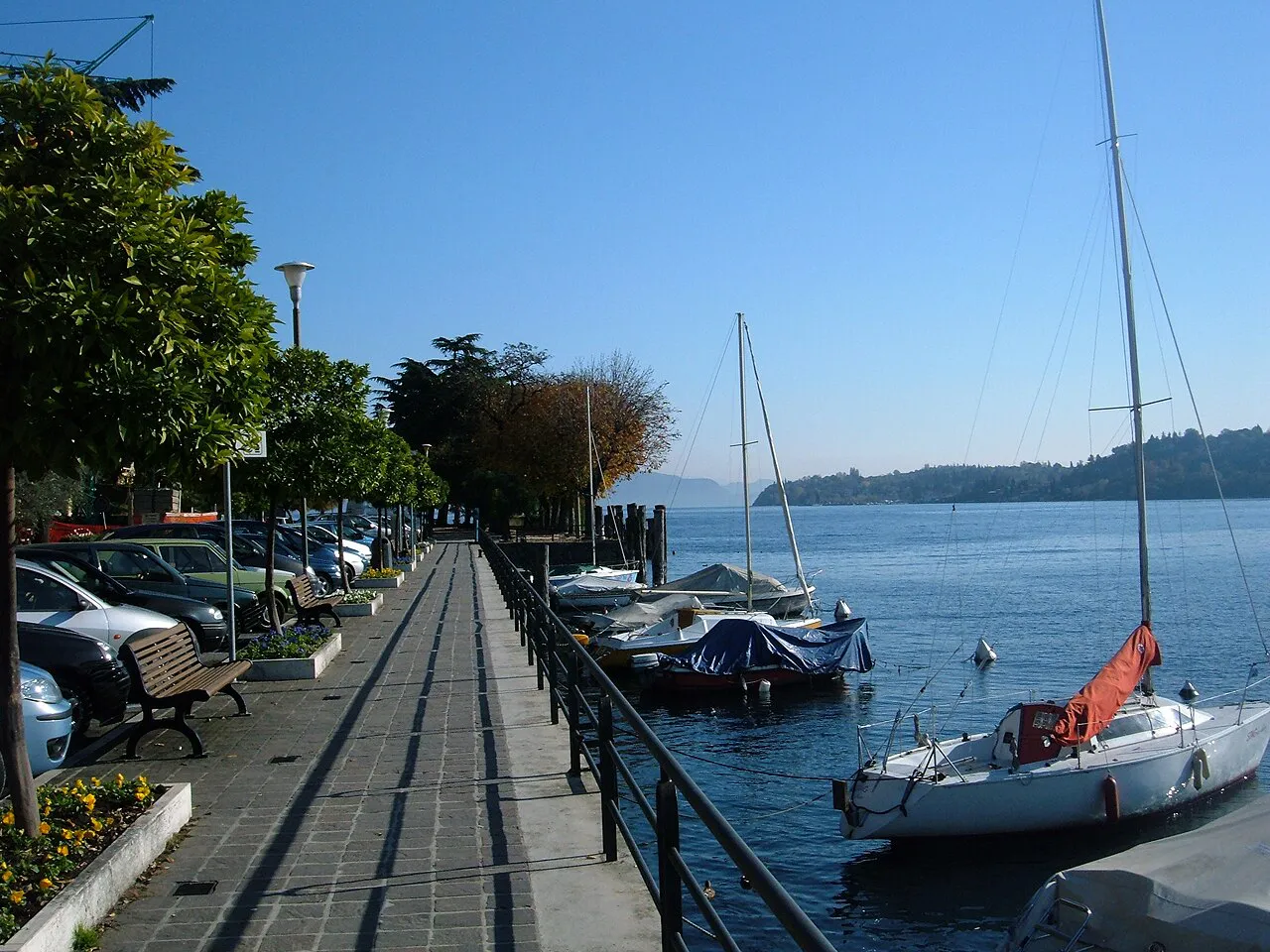 Paved lakeside walkway beside moored sailing boats on the Salò waterfront, Lake Garda