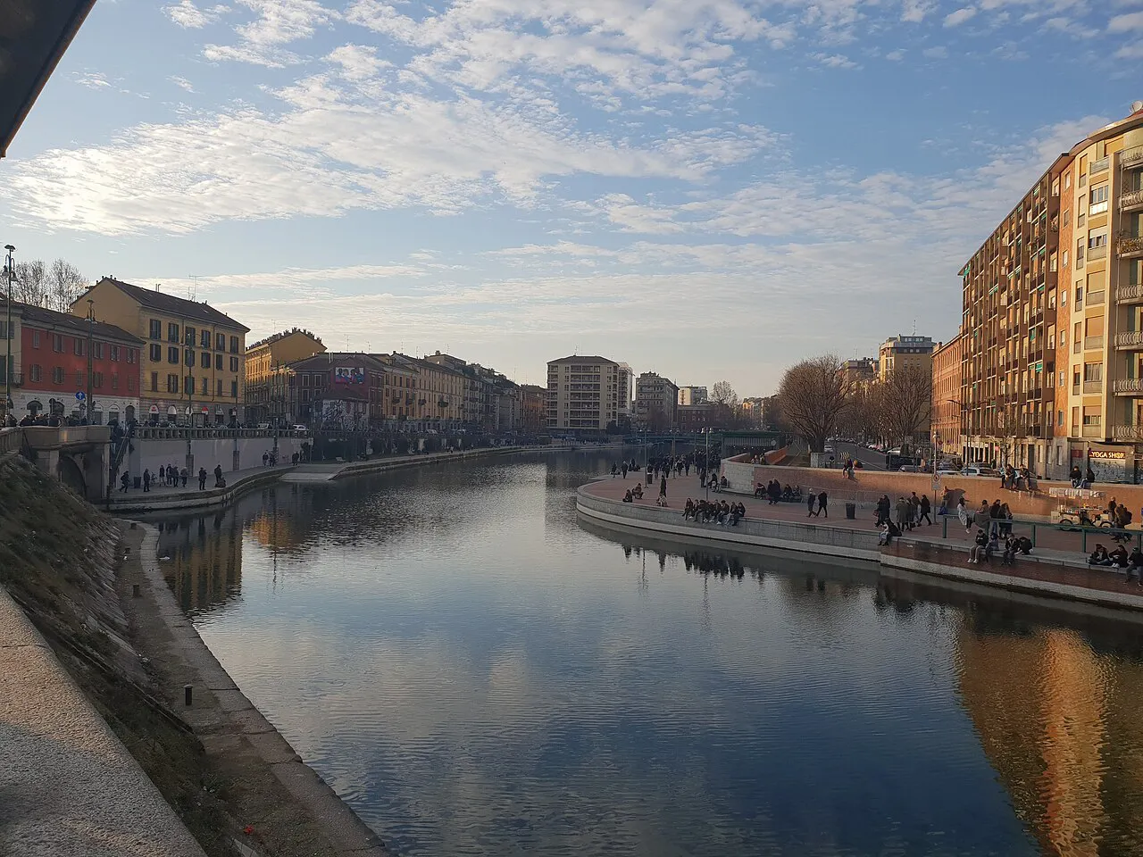 The Darsena basin in Milan in soft evening light, with waterside promenades and apartment blocks