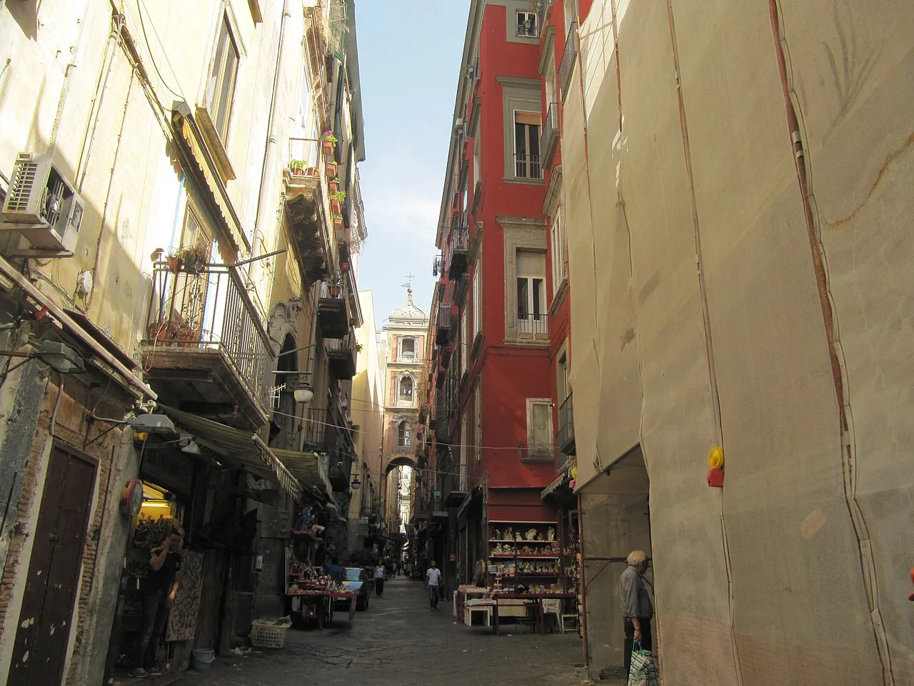 Narrow Via San Gregorio Armeno with its small stalls and old facades in the historic centre of Naples