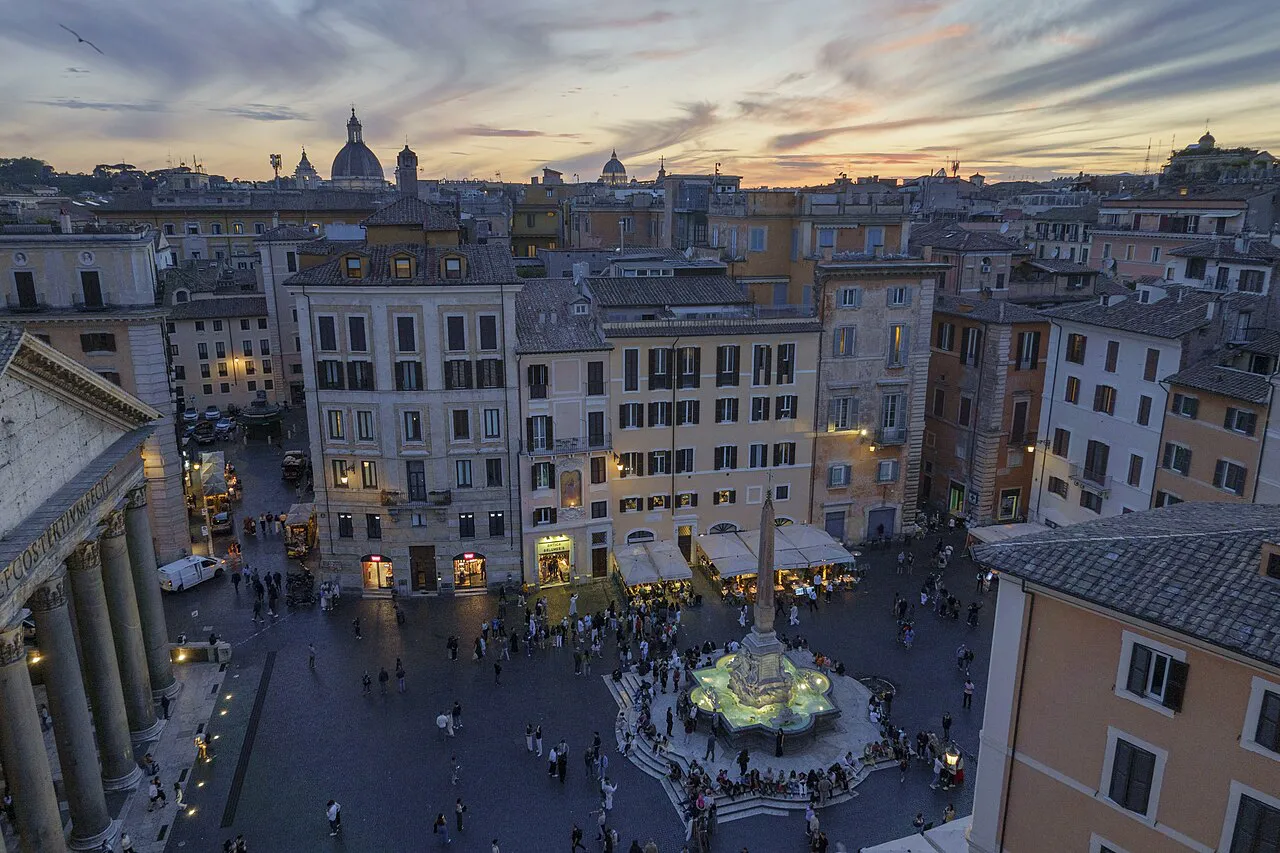 Piazza della Rotonda in Rome seen from above at dusk, with the lit fountain and the Pantheon portico