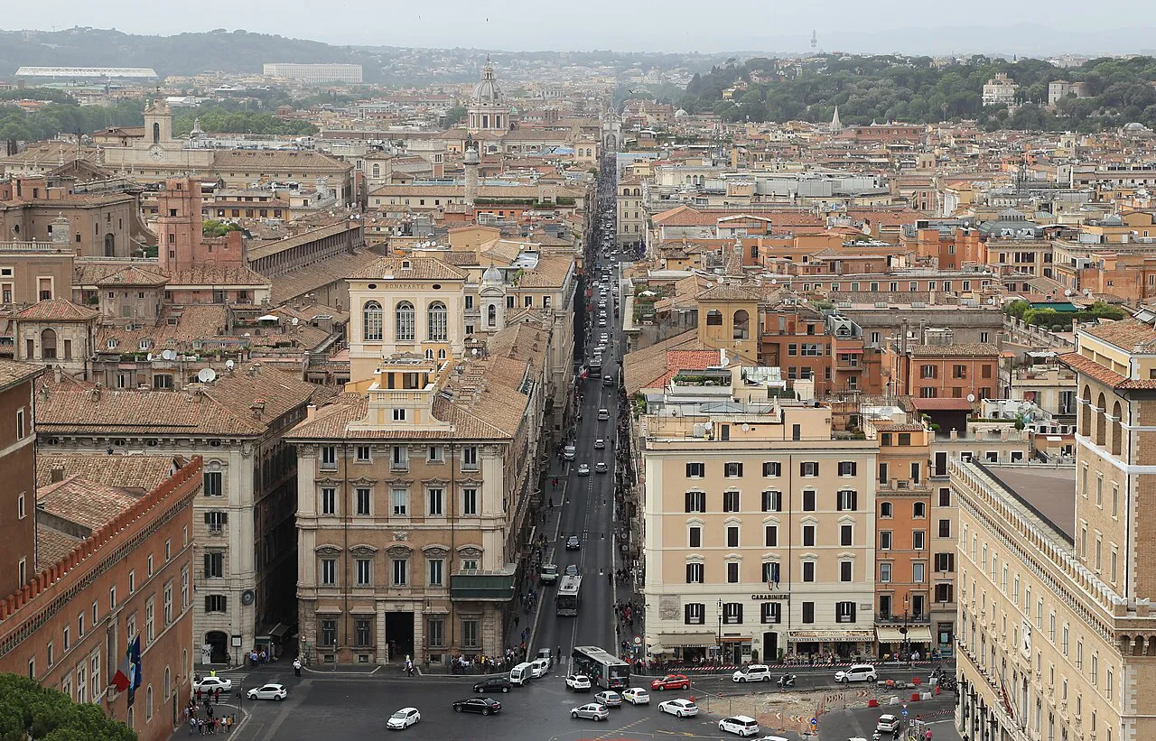 Elevated view straight down Via del Corso through the rooftops of central Rome