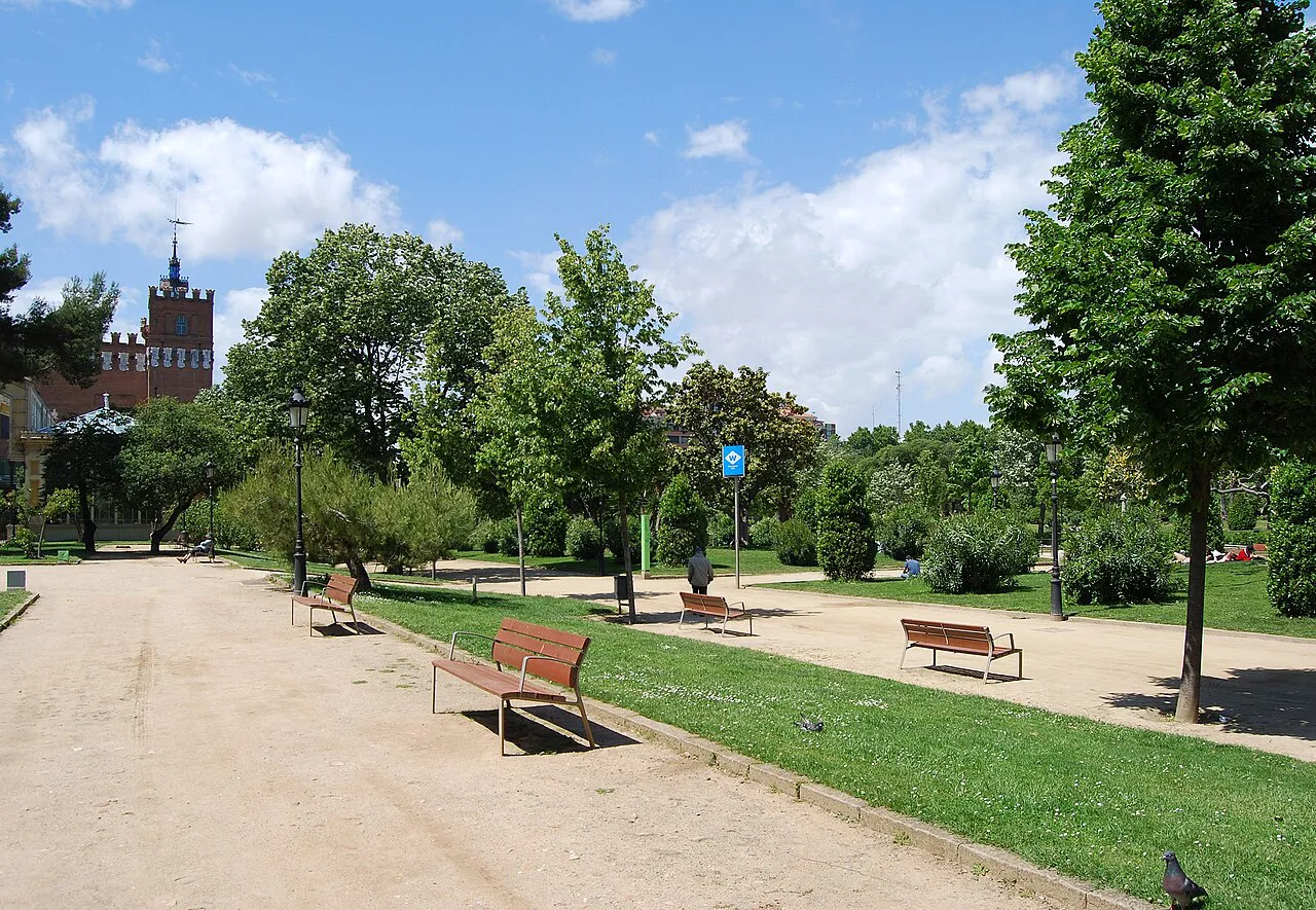 Wide sandy path with benches and lawns in Parc de la Ciutadella, Barcelona