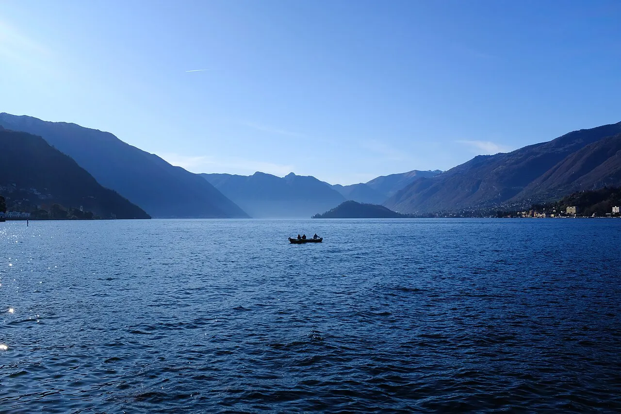 Open blue water of Lake Como stretching between mountain ridges, seen from Bellagio