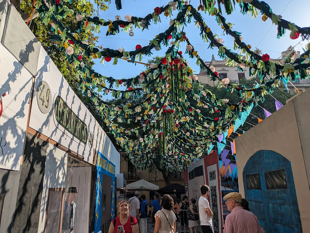 Gràcia street hung with handmade garland decorations during the Festa Major de Gràcia in Barcelona