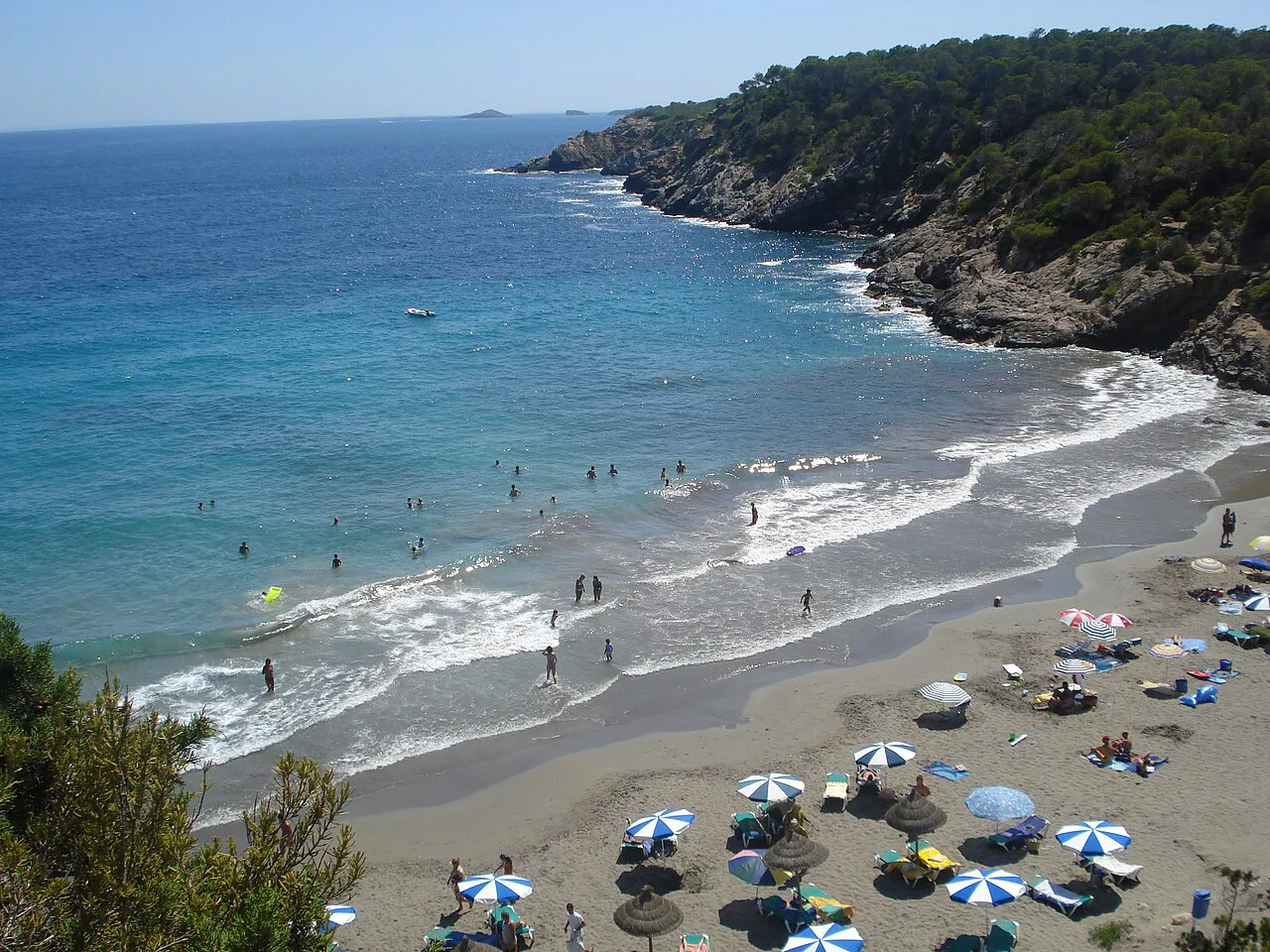 Sandy cove of Cala Boix below pine-covered cliffs on Ibiza's northeast coast, in Santa Eulària des Riu