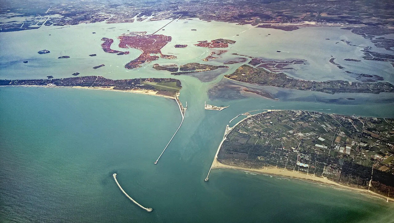 Aerial view of the Venetian lagoon and the Porto di Lido inlet, with Venice and its islands beyond