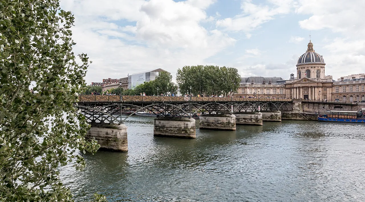 Pont des Arts footbridge crossing the Seine towards the domed Institut de France, Paris