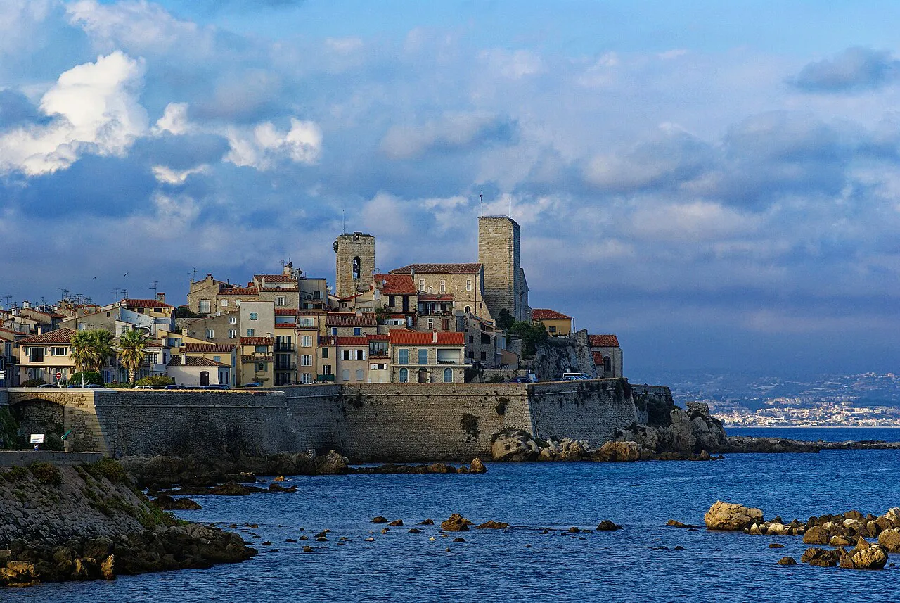 Antibes old town with its two stone towers rising above the sea walls, seen from Pointe de l'Ilette