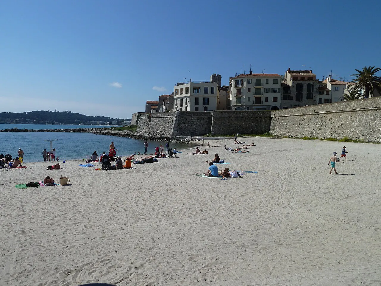 Sandy Plage de la Gravette tucked beneath the old ramparts and houses of Antibes