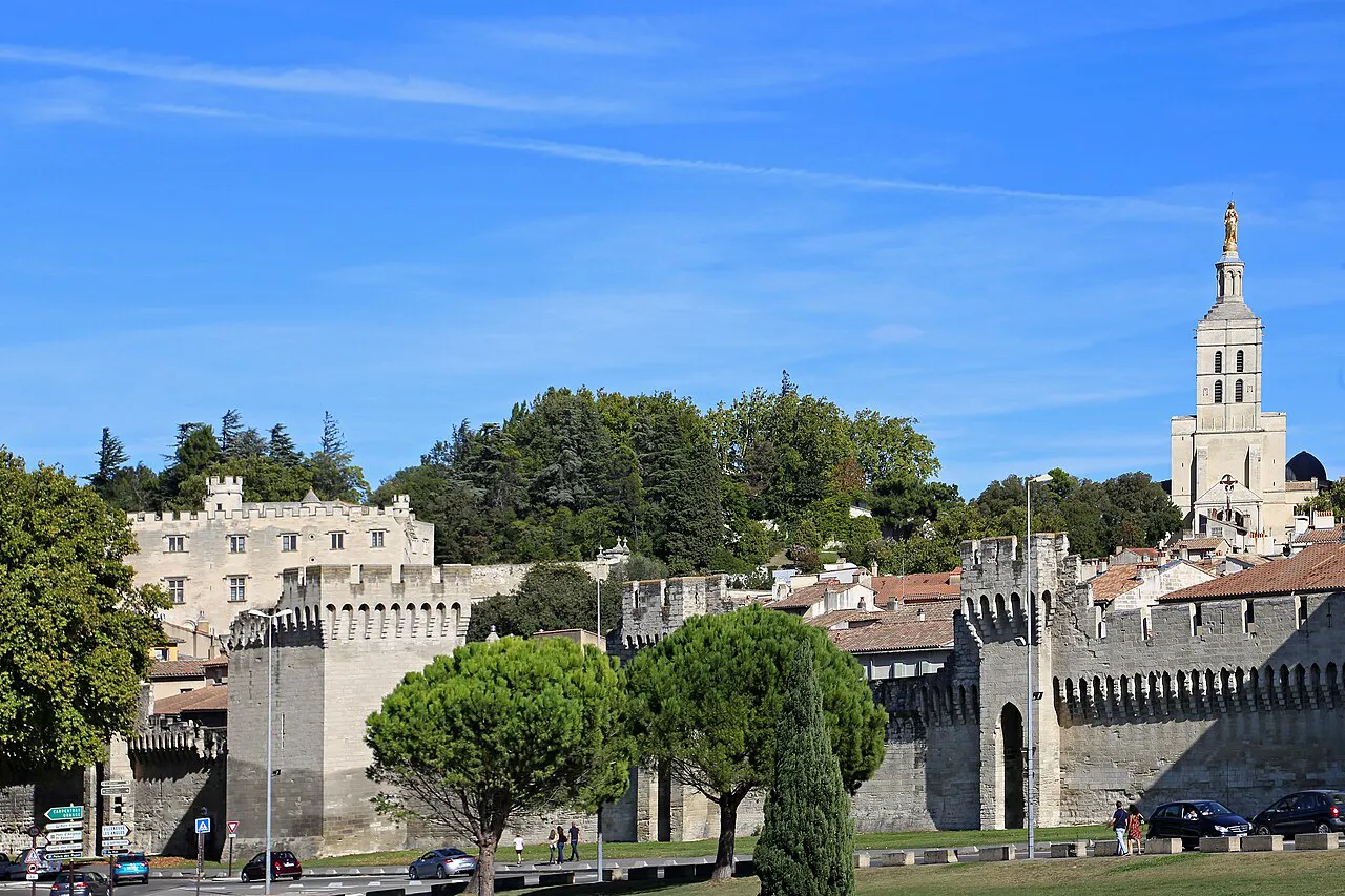 Avignon’s crenellated city walls with the gilded statue atop the Notre-Dame des Doms tower behind