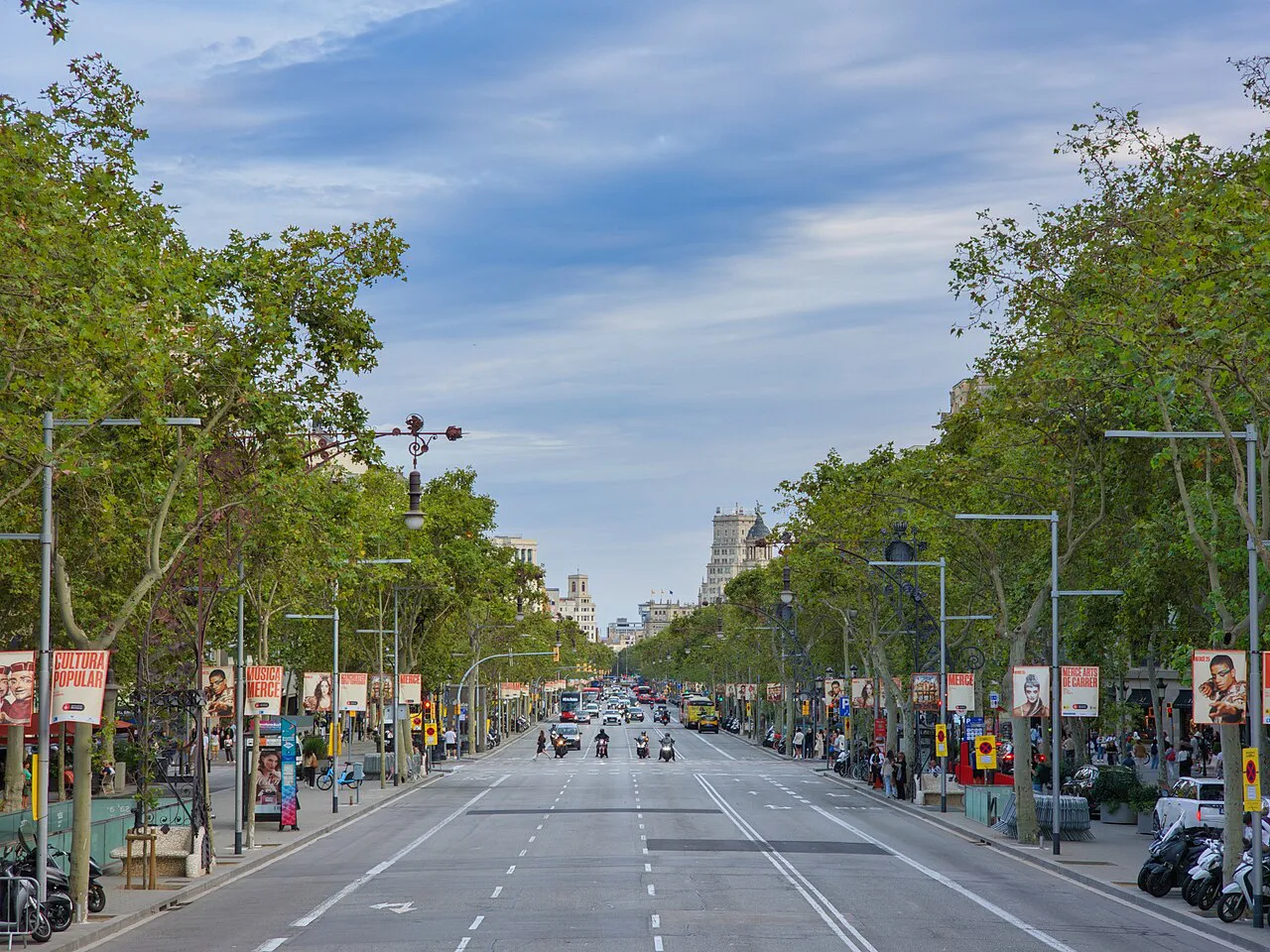 Long tree-lined Passeig de Gràcia boulevard stretching through Barcelona's Eixample