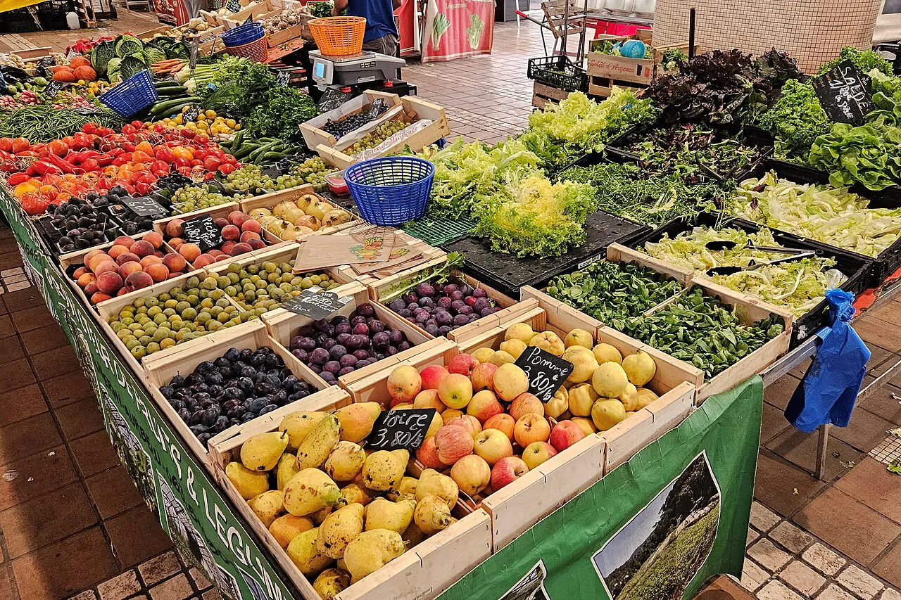 Fruit and vegetable stall piled with fresh produce at the Marché Forville food market in Cannes