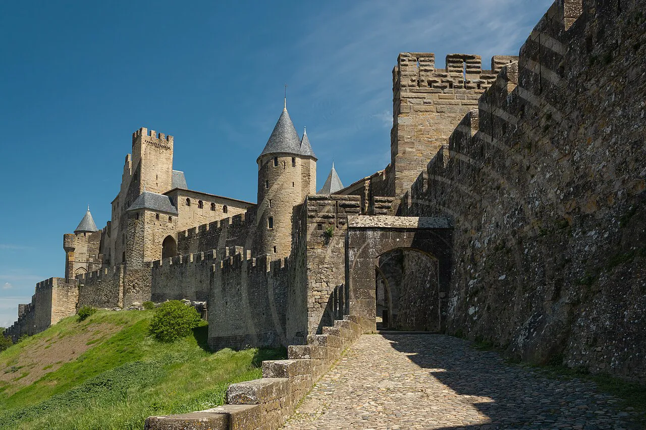 Cobbled ramp climbing to the Porte d'Aude gate and towers of the Cité de Carcassonne