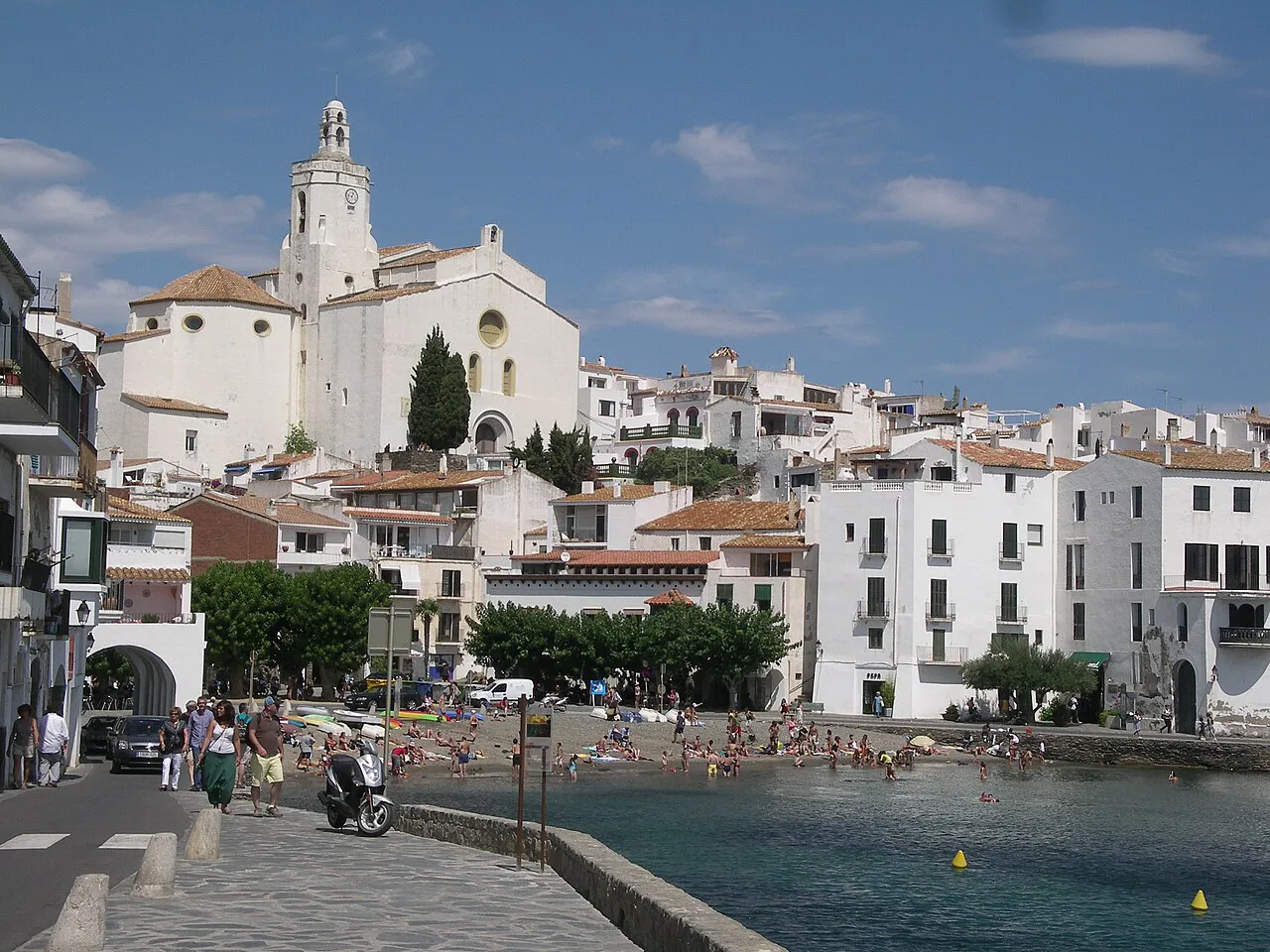 Whitewashed waterfront of Cadaqués below the church of Santa Maria, beside a small town beach