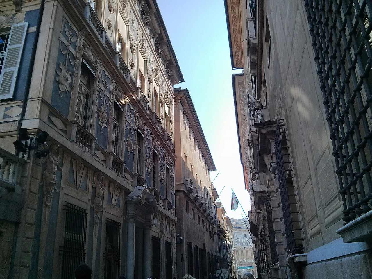 Narrow Via Garibaldi lined with tall decorated Renaissance palazzi, Genoa