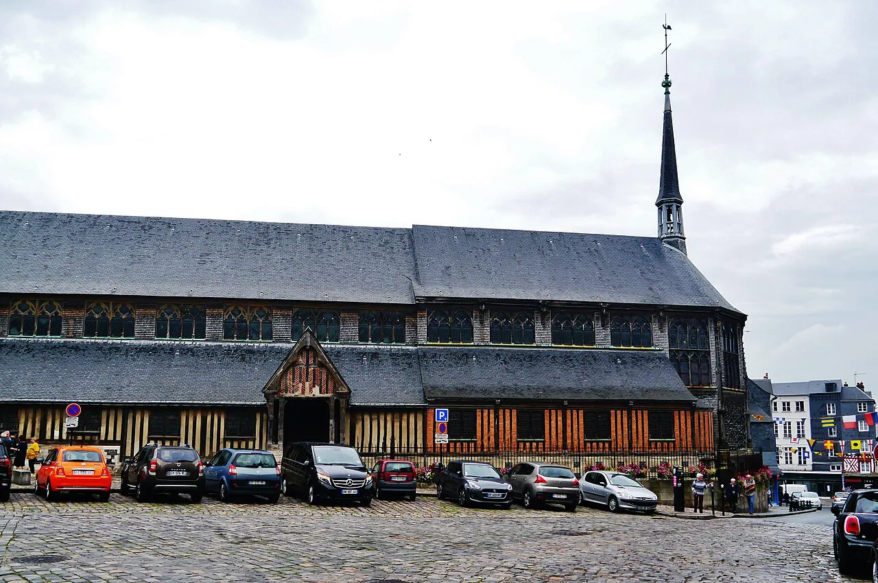 Timber-built Église Sainte-Catherine with its slate roofs and spire on a cobbled square in Honfleur