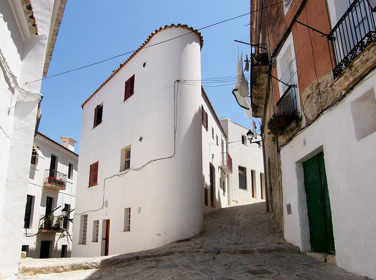 Whitewashed houses on a sloping cobbled lane in Ibiza's old town, Dalt Vila