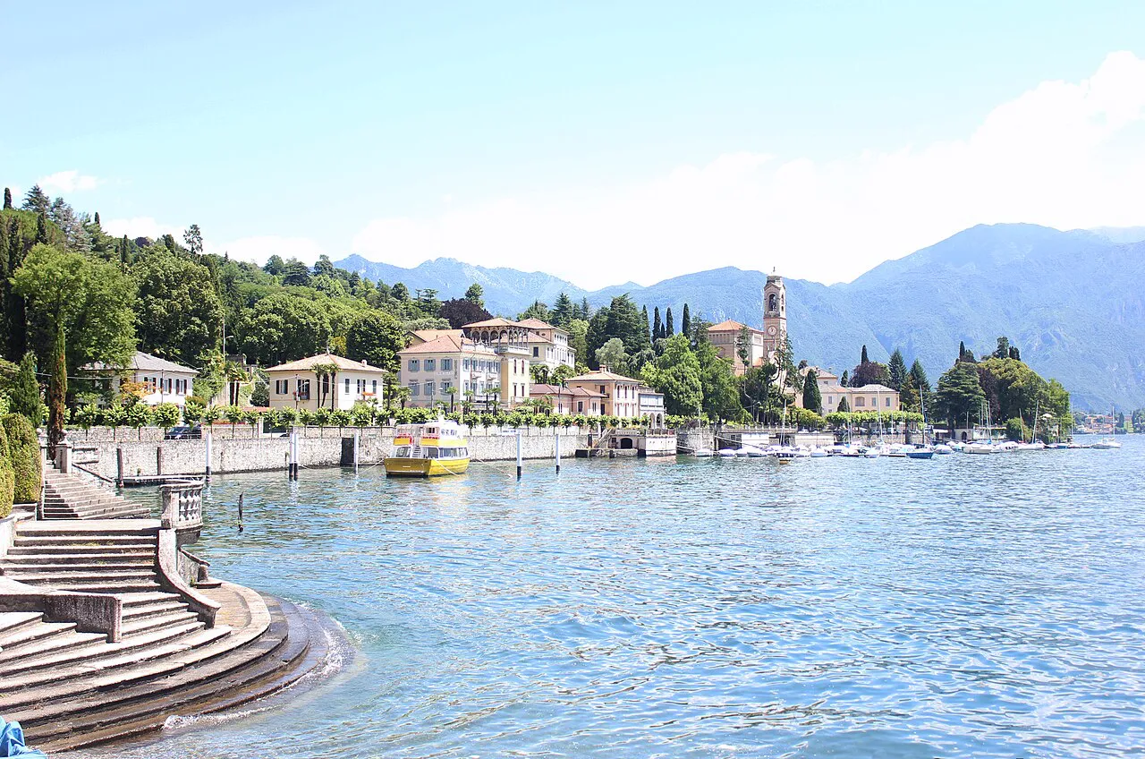Tremezzo's waterfront with stone steps, lakeside villas and a church tower on Lake Como