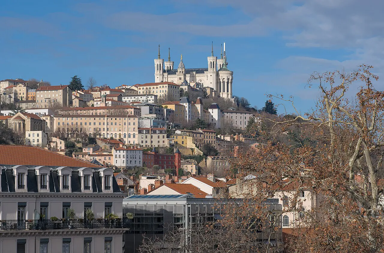 Fourvière hill and its basilica rising above the rooftops of Lyon on a sunny day
