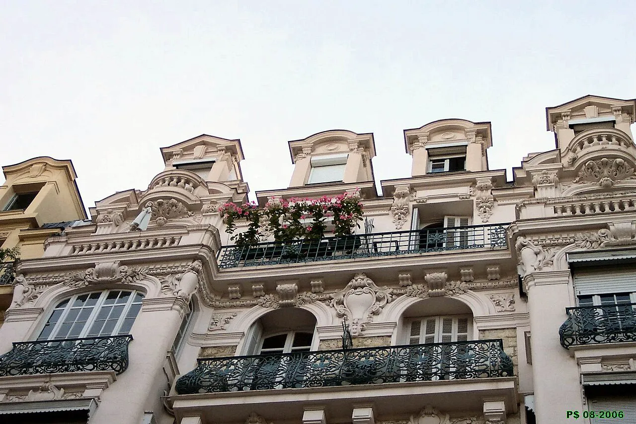 Ornate Belle Époque facade with wrought-iron balconies on the Palais Albert 1er in Nice's Musiciens quarter