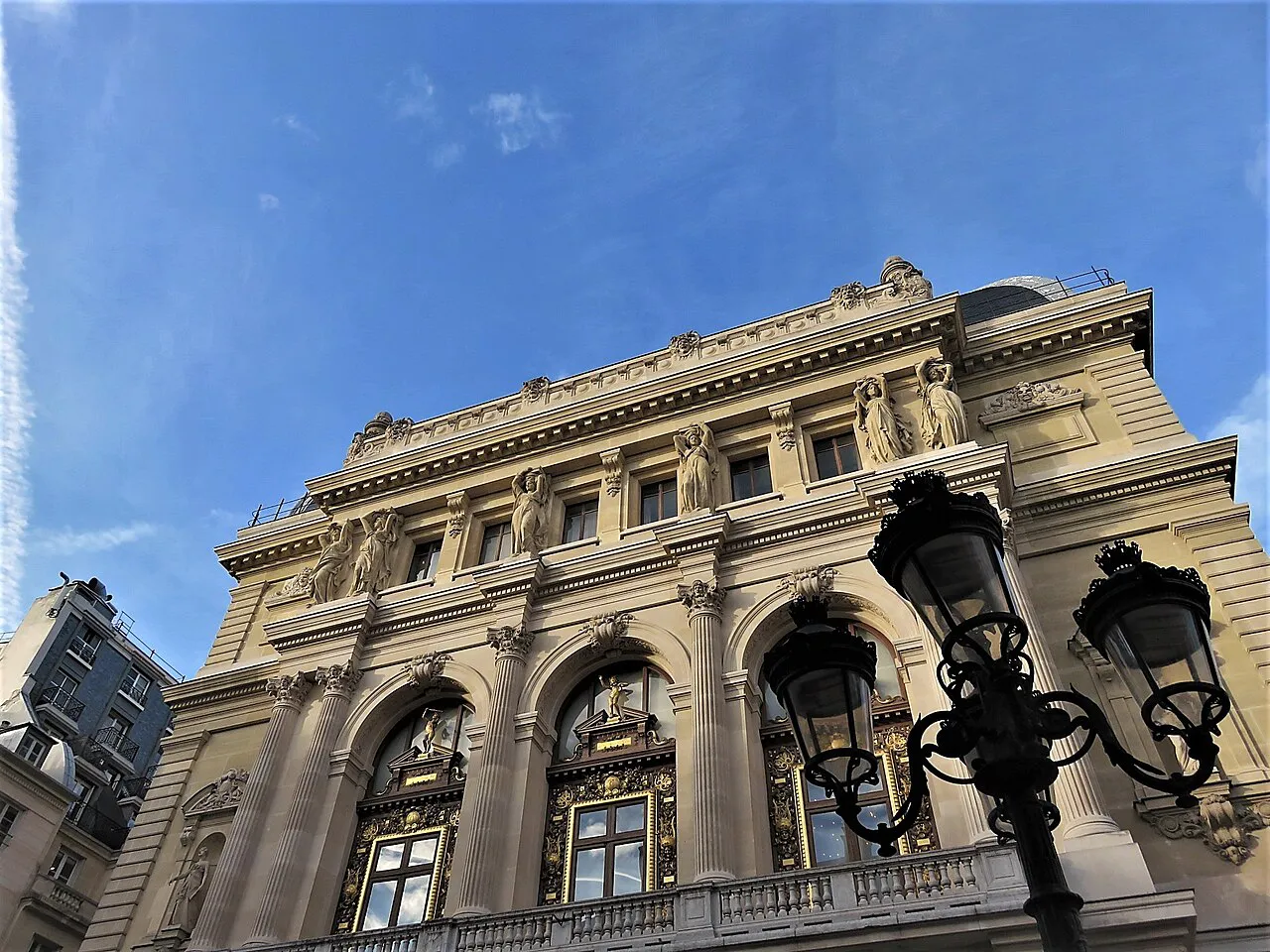 Facade of the Opéra-Comique with sculpted arched windows and a street lamp, Paris 2nd arrondissement