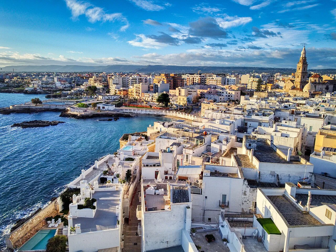 Monopoli’s white old town and cathedral bell tower above the Adriatic shoreline