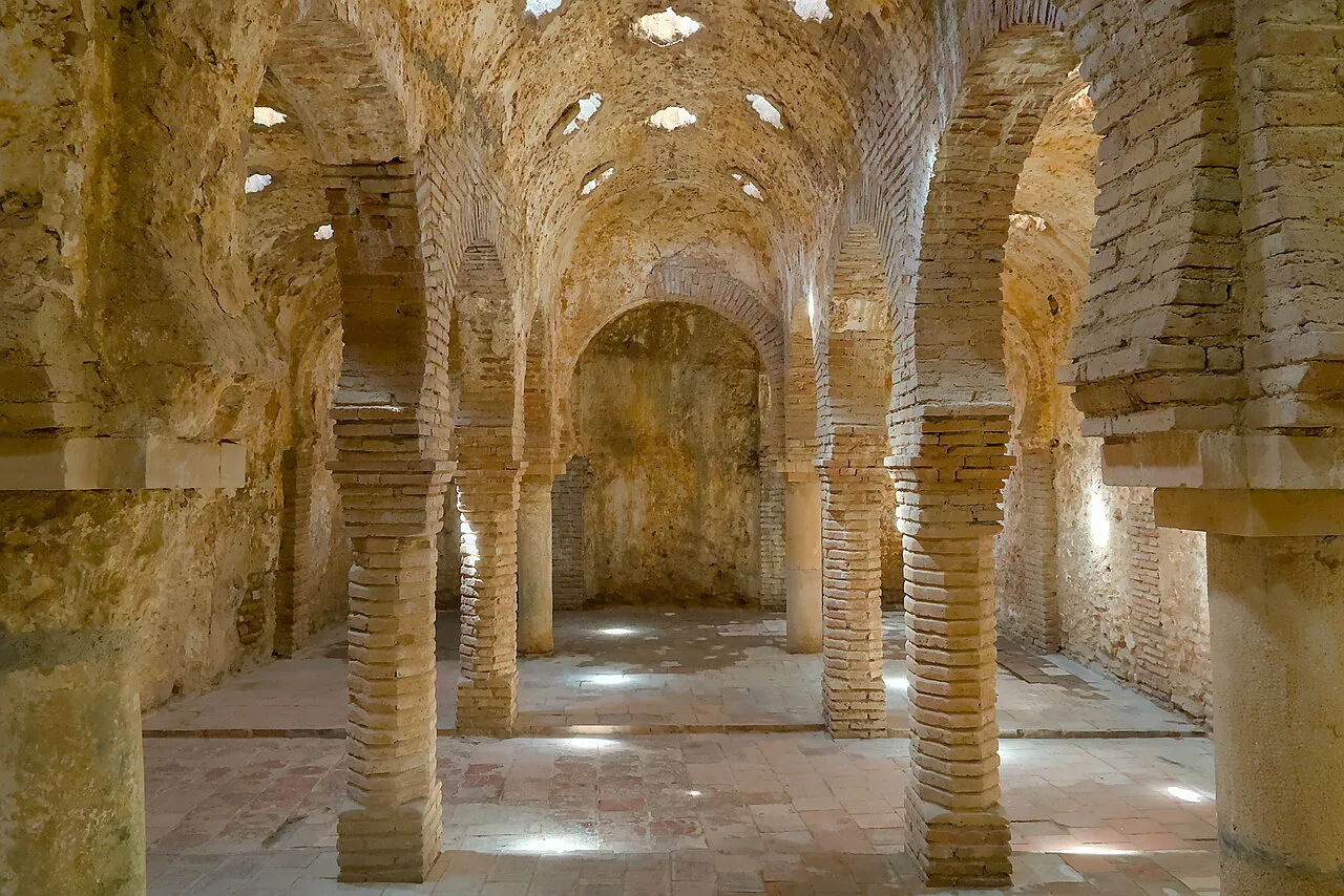 Brick horseshoe arches and star-shaped skylights inside Ronda's 13th-century Arab Baths