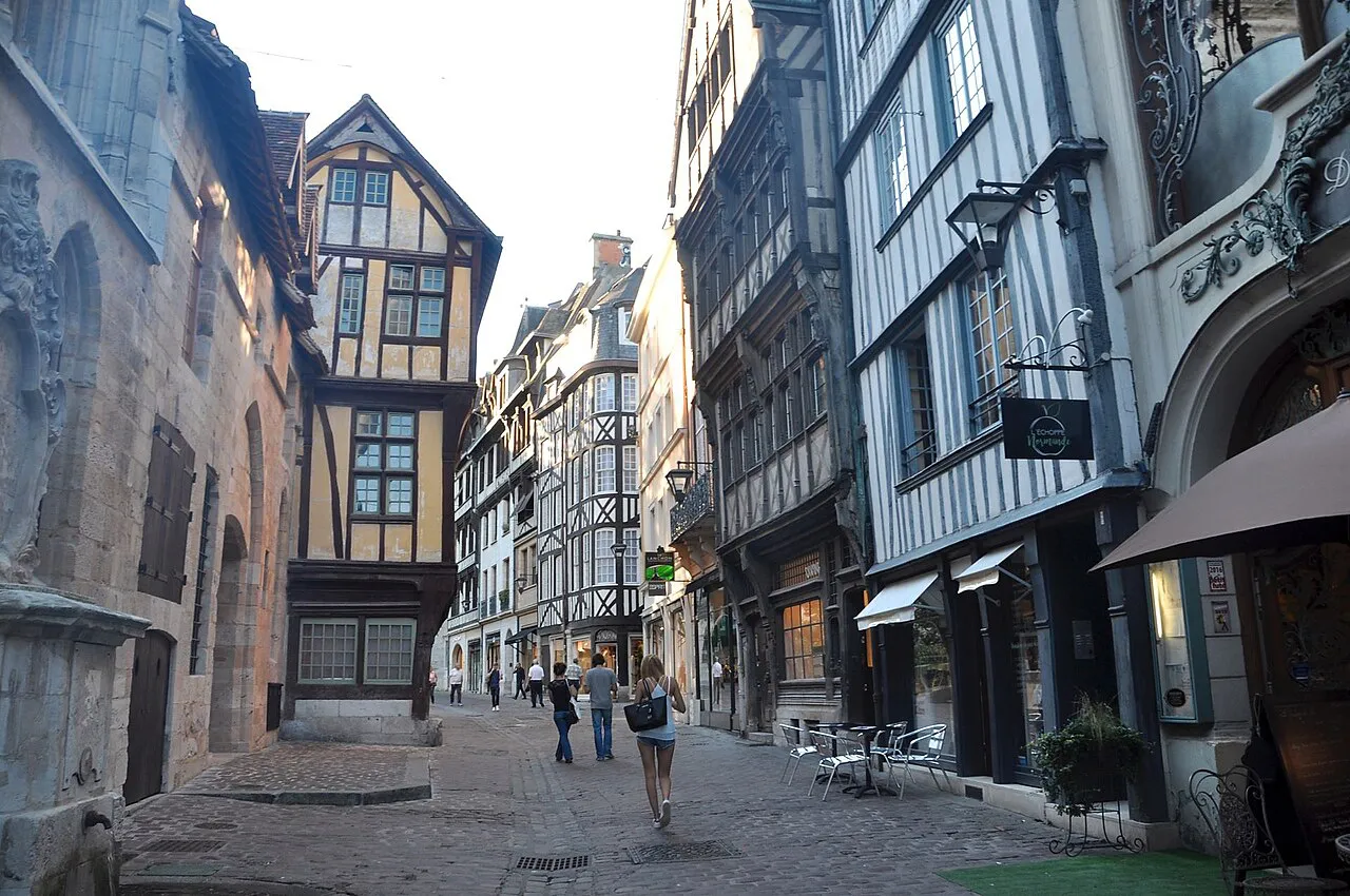 Cobbled Rue Saint-Romain in Rouen lined with leaning half-timbered houses