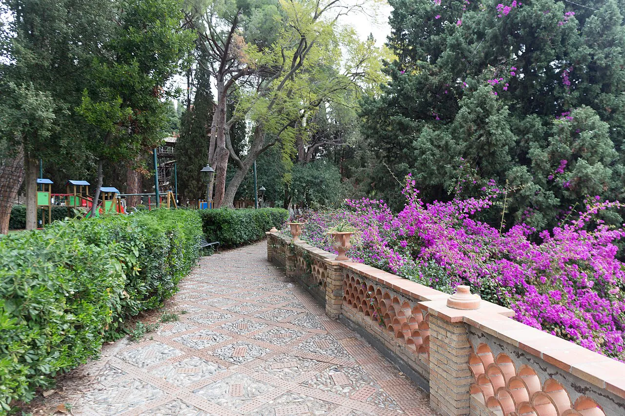 Patterned brick path beside bougainvillea in the Villa Comunale public gardens of Taormina