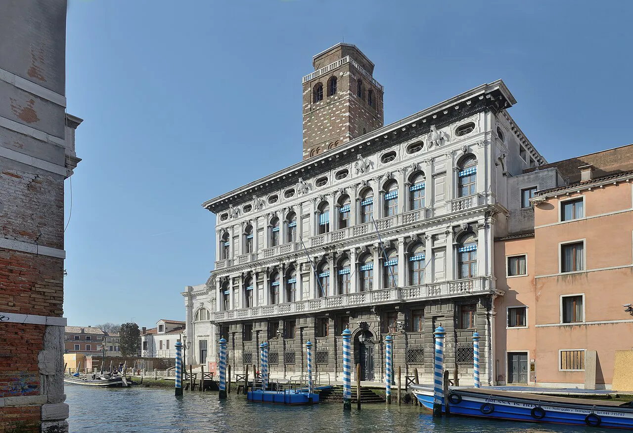 Palazzo Labia and its bell tower beside the Cannaregio Canal in Venice, with boats moored below