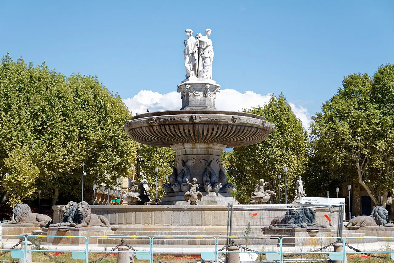 Fontaine de la Rotonde in Aix-en-Provence with its tiered basin and statues, framed by plane trees
