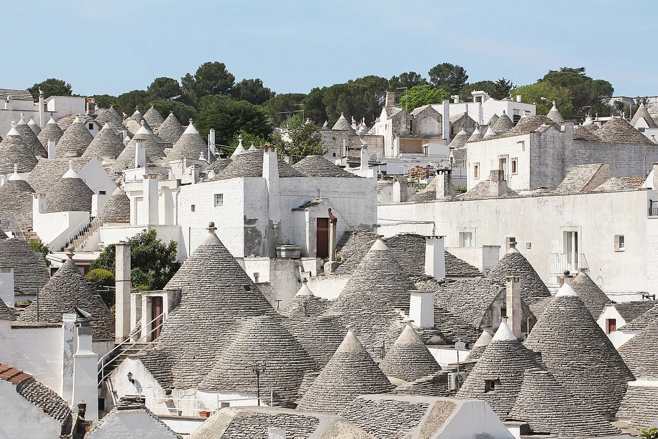 Dense cluster of conical trulli roofs and whitewashed walls spreading across Alberobello