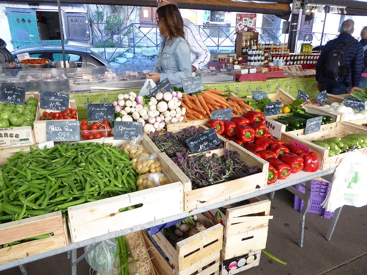 Crates of green beans, peppers and fresh vegetables on a stall at the Marché Provençal in Antibes