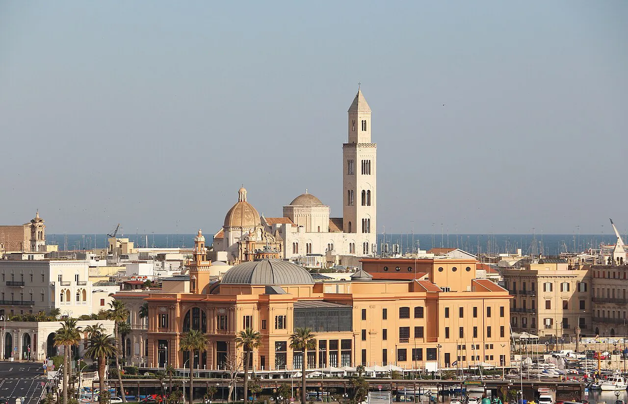 Bari skyline with the cathedral bell tower and domes rising above the old town and seafront buildings