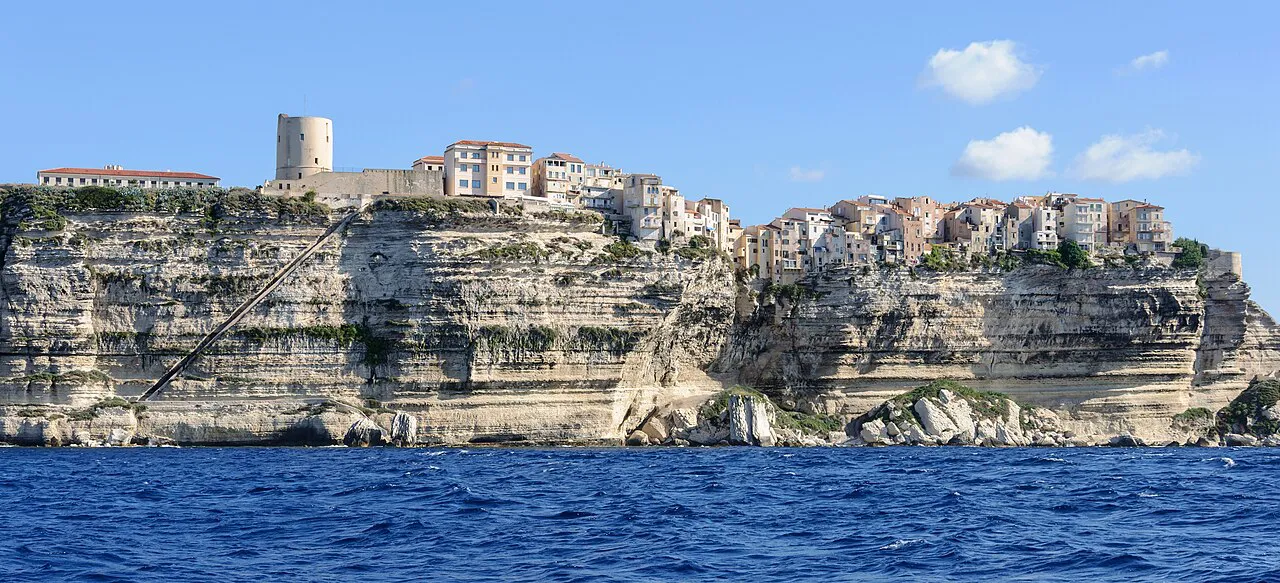 Bonifacio upper town perched on top of sheer white limestone cliffs above the deep blue sea