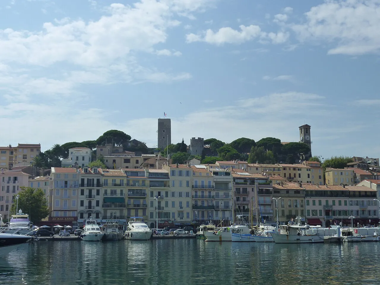 Boats in the Vieux Port of Cannes below the Suquet hill with its tower and church
