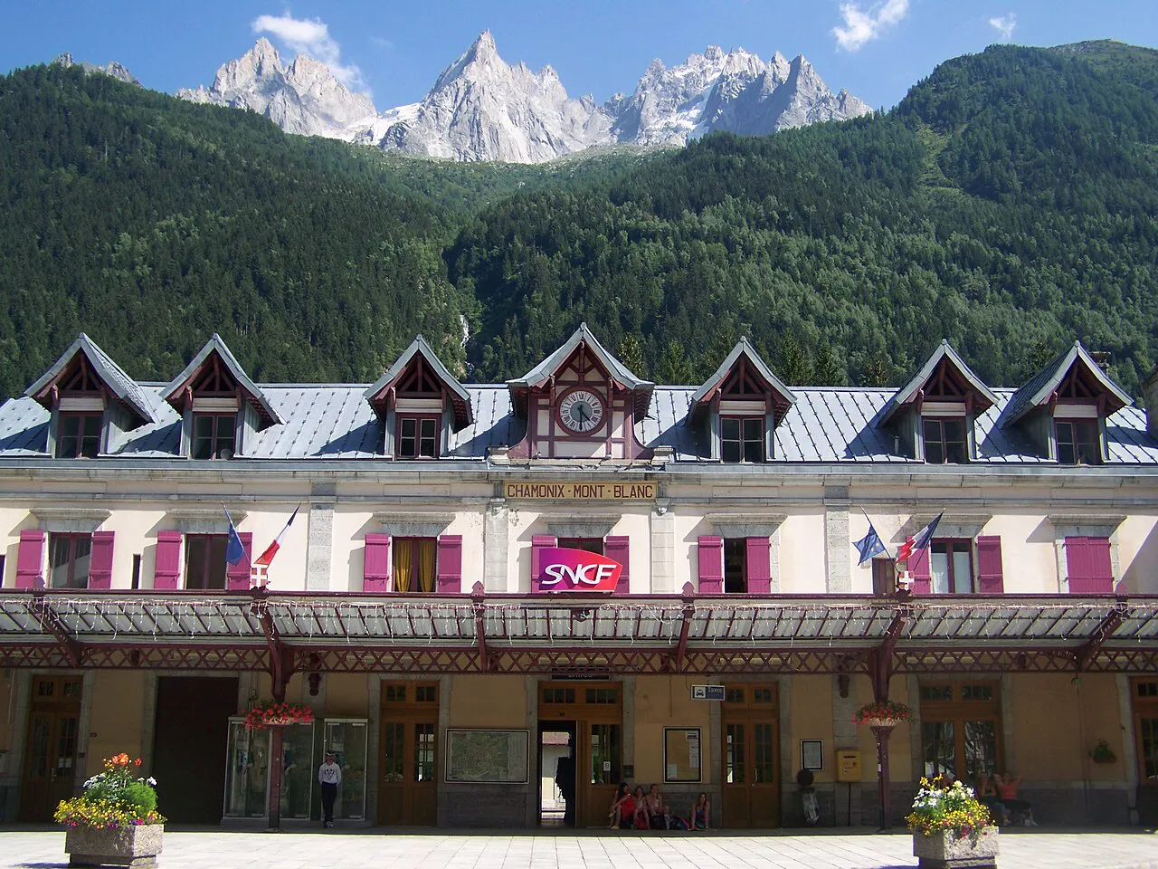 Chamonix-Mont-Blanc railway station facade with dormer windows, below forested slopes and granite needles