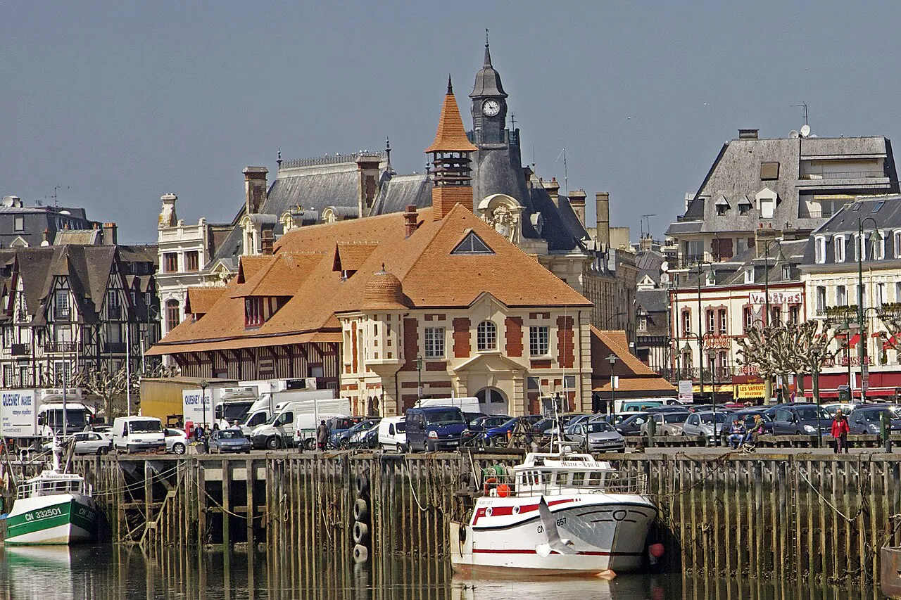 The half-timbered fish market and clock tower beside the harbour of Trouville-sur-Mer