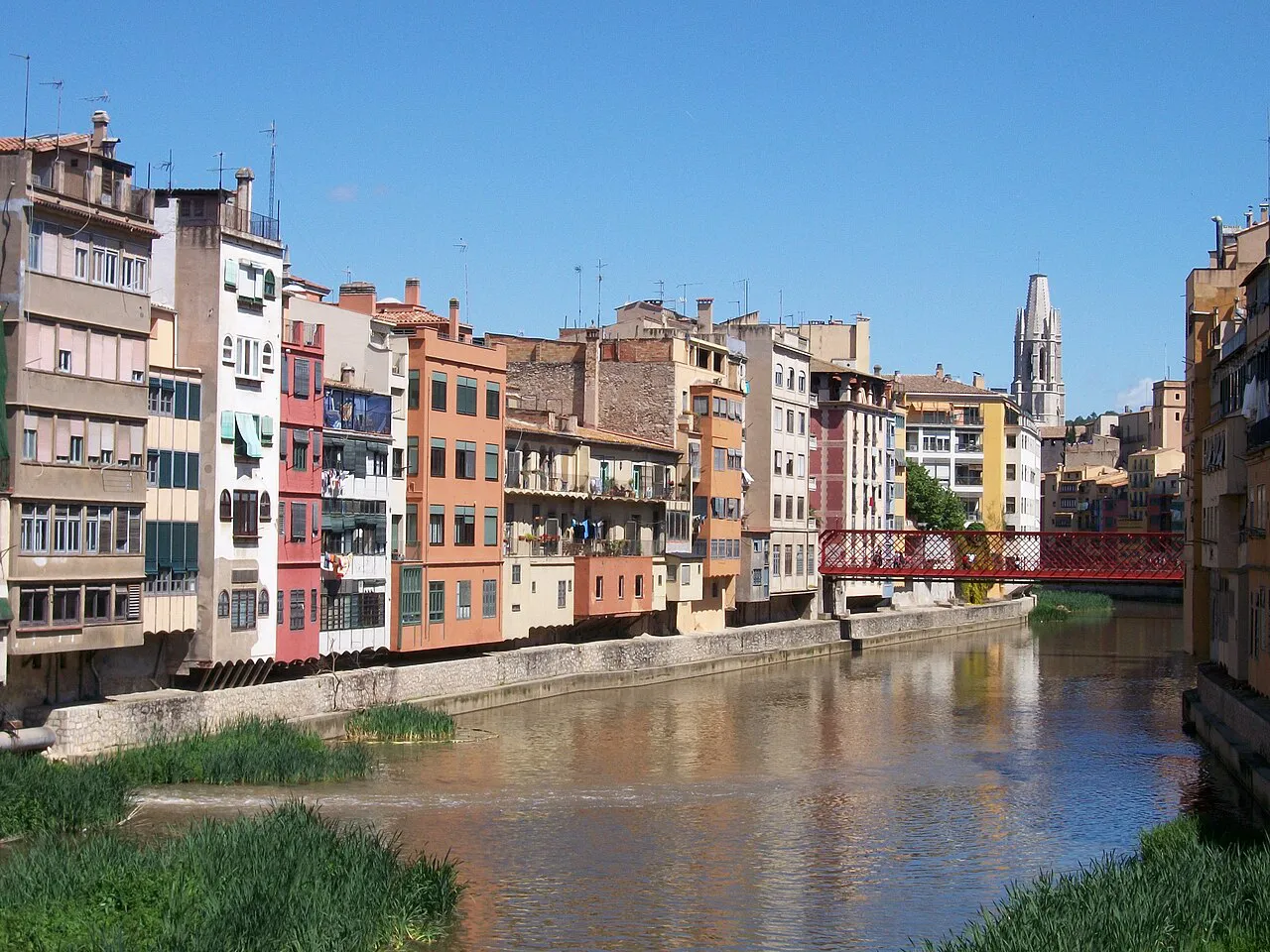 Colourful houses along the Onyar river with the Sant Feliu bell tower behind, Girona