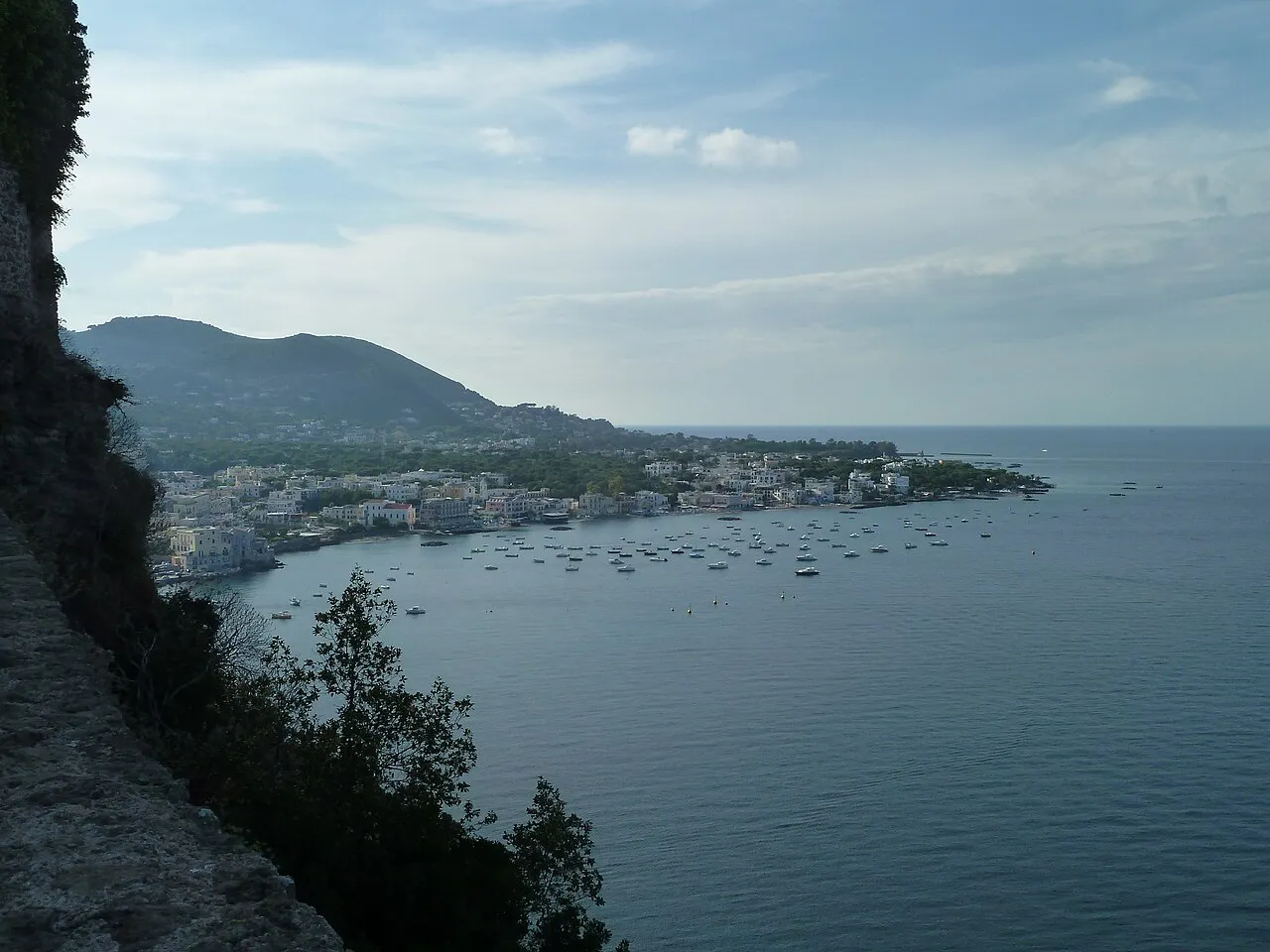 View along Ischia's bay towards the town and green hills from the cliffs near Ischia Ponte